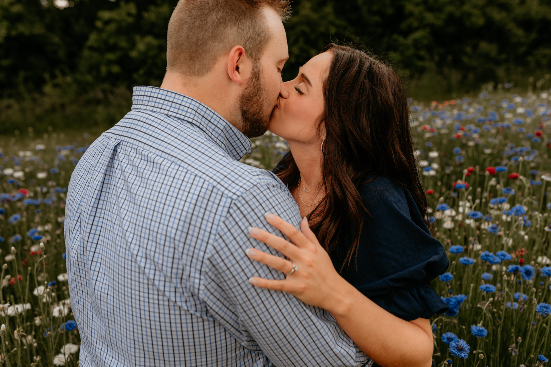 A couple in love embracing in a sunlit flower field at Middle Springs Farm, captured by Winchester Kentucky Photographers A Pair of Perry's Photography.